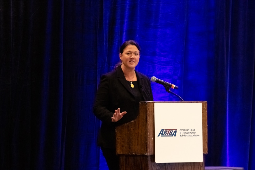 Woman standing at podium speaking