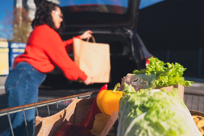 Woman_Loading Groceries_Into_Trunk